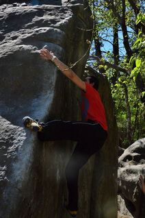 Climbing a corner style boulder problem in Fontainebleau while using a left toe hook