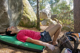 Lying on a crash pad with my eyes closed in the Forest of Fontainebleau