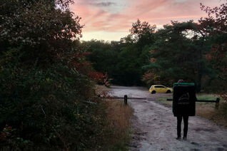 Walking back to our car wearing a crash pad during sunset