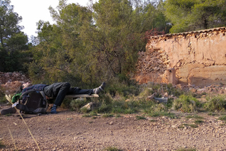 Resting on a wooden 'bench' during the Puig Campana round trek